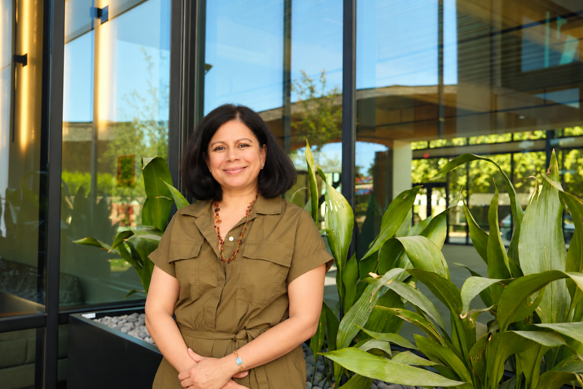 Dr. Seema Shah surrounded by greenery outside Apsara Women's Health.